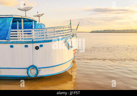 PORTO VELHO, BRAZIL - JUNE 17, 2017: Stern of the boats on the banks of the Rio Madeira river on a sunset. Boats departs from Estrada de Ferro Madeira Stock Photo