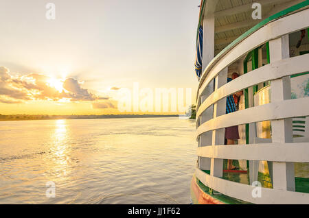 PORTO VELHO, BRAZIL - JUNE 17, 2017: Landscape of a traditional and classic boat ride on Rio Madeira river at sunset. Boats departs from Estrada de Fe Stock Photo