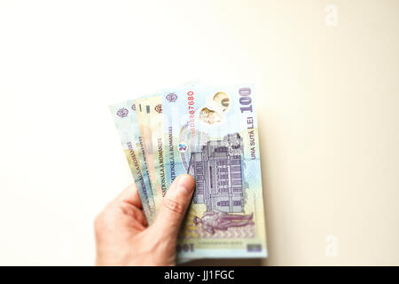 Man hand with romanian money lei Stock Photo