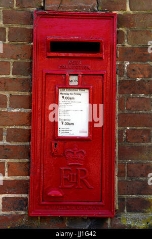 Traditional Royal Mail red post box on the wall in the village of Selborne, Hampshire, UK. Stock Photo