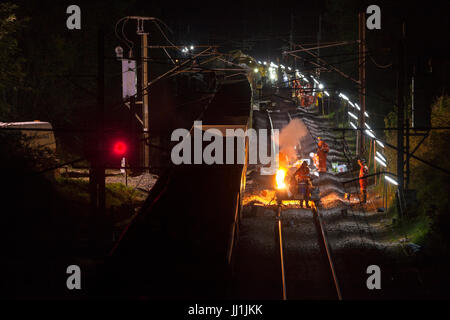 Bay Horse (South of Lancaster)  thermite welding rails during night time  track renewal engineering work  on west coast main line for Network Rail Stock Photo