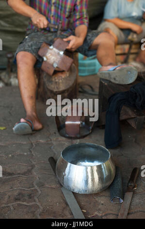 Craftsman  beating out alms bowls in Monks Bowl Village Soi Ban Baat Stock Photo