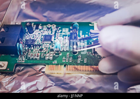 Electronic technician repairing computer hardware in the lab. Close up image. Stock Photo