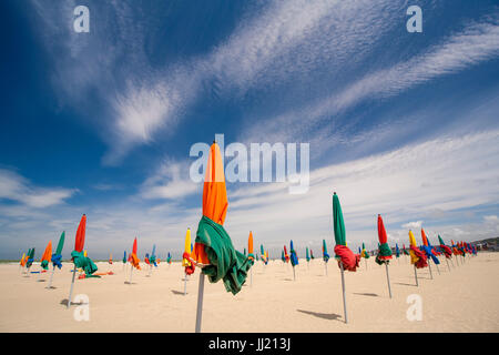 Colourful beach umbrellas (parasols) on Deauville sandy beach (plage). Stock Photo