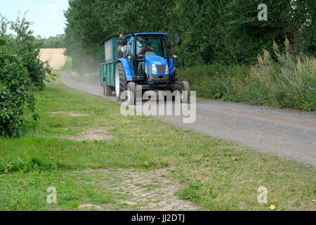 Farm tractor transporting fruit and vegetable picking public around a Pick Your Own farm in West Sussex, UK Stock Photo