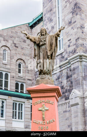 Montreal, Canada - May 27, 2017: Closeup of Jesus Christ statue with open arms at Saint-Denis Catholic Church in Montreal's Plateau Mont Royal in Queb Stock Photo