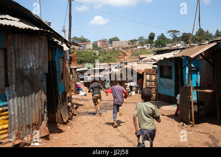 Kids running though the streets of Kibera slum, Nairobi, Kenya, East Africa Stock Photo