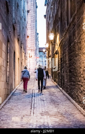 Montreal, Canada - May 27, 2017: Old town area with people walking up street in evening outside empty alleys in Quebec region city Stock Photo