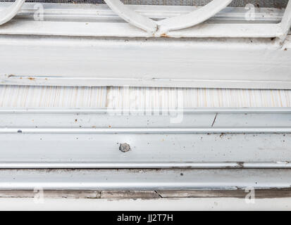 Metal rail of the sliding glass door with the dirty stain behind the urban house. Stock Photo