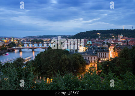 Bridges over Vltava River and buildings at the Mala Strana District (Lesser Town) in Prague, Czech Republic, viewed slightly from above in the evening Stock Photo