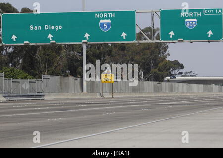 San Ysidro, CA, USA. 17th July, 2017. The last of ten immigrant crossing signs that once stood on either side of Interstates 5 and Interstate 805 near the US-Mexico Border is still visible in San Ysidro, CA. Caltrans has said that this last one will not be replaced once it is gone. The signs were created based on photos taken by former Los Angeles Times Photographer Don Bartletti, and created by Caltrans employee John Hood in the early 1990s after too many deaths occurred on the freeway when the San Diego Border Patrol Sector was literally overrun with migrants crossing. (Credit Image: © John Stock Photo