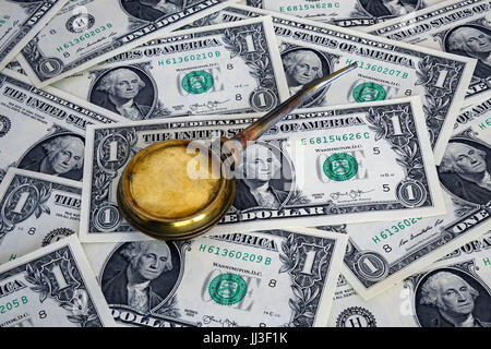 Berlin, Germany. 23rd Mar, 2017. ILLUSTRATION - A small oil canister lies on top of several one-dollar bills. Taken on 23.03.2017. Since the Second World War, trading of oil has mainly been calculated in US dollars. Money used in this way is also known as 'petrodollar'. - NO WIRE SERVICE - Photo: Sascha Steinach/dpa-Zentralbild/dpa | usage worldwide/dpa/Alamy Live News Stock Photo