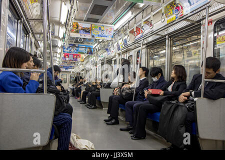 TOKYO, JAPAN - NOVEMBER 22, 2016, passengers commuting in subway train Stock Photo