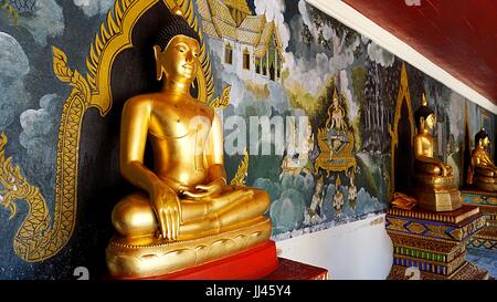 Buddha image statues with mural painting background on behind at Wat Phratrat Doi Suthep, Thai temple in Chiang Mai, Thailand. Stock Photo