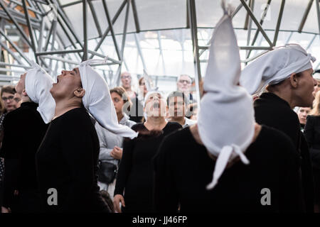London, UK. 14th July, 2017. Bouchra Ouizguen’s Corbeaux performed at Serpentine Park Nights. Ten women from Morocco and ten from London, brought together in a series of workshops make piercing sounds and extraordinary cries in a stirring display of movement and sound. © Guy Corbishley/Alamy Live News Stock Photo
