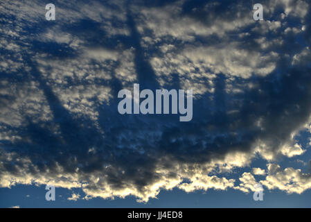 Strange shadows reminiscent of a city-scape in evening clouds Stock Photo