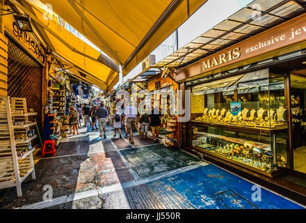 Tourists shopping and sightseeing in an outdoor market in the Plaka district of Athens Greece on a warm summer day Stock Photo