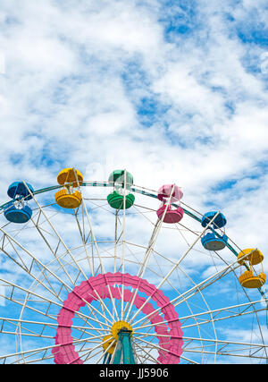 Colorful ferris wheel over blue sky. Stock Photo