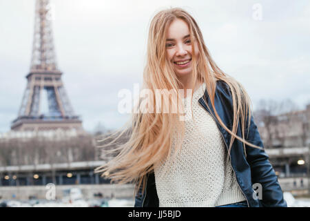 happy young woman in Paris near Eiffel tower, smiling girl traveling portrait, student in Europe Stock Photo