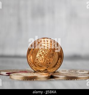 Digital currency physical gold titan bitcoin coin on the gold money. Silver background. Stock Photo