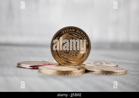 Digital currency physical gold titan bitcoin coin on the money. Business concept. Stock Photo