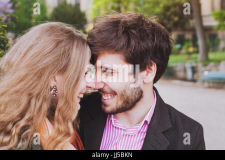 portrait of young happy couple laughing together outside, affectionate man and woman having fun Stock Photo