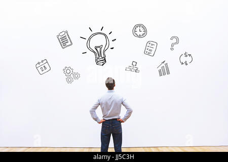 idea or innovation concept, businessman looking at the sketch on white background Stock Photo