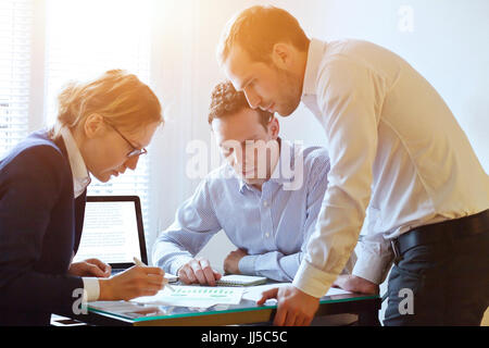 brainstorming, teamwork concept, business team working on a project, busy caucasian people in the office Stock Photo