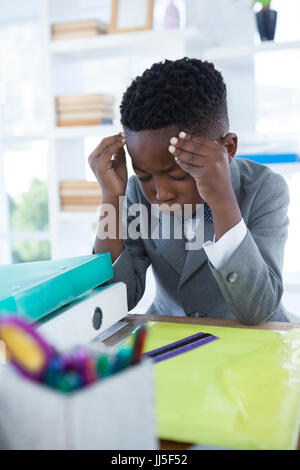 Businessman pointing while working at desk in office Stock Photo