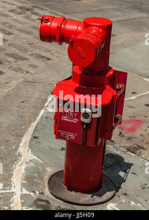 Bright red fire hydrant near in Fulton Street at South Street Sea Port in Manhattan Stock Photo