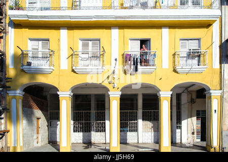Woman on a balcony doing laundry in Old Havana, Cuba Stock Photo