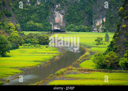 Tourist ride boat for travel sight seeing Rice field on river 'Ngo Dong' at TamCoc, Ninhbinh, Vietnam; Stock Photo