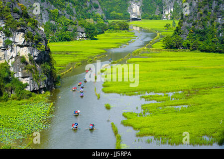 Tourist ride boat for travel sight seeing Rice field on river 'Ngo Dong' at TamCoc, Ninhbinh, Vietnam; Stock Photo