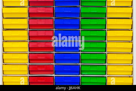 Colored plastic drawer keeping parts in workshop;storage facility Stock Photo