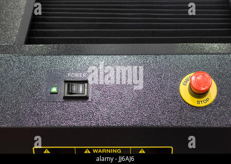 On/Off Switch and emergency stop button in black equipment ;Security push switch;shut down;For safety issue;selective focus Stock Photo