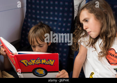 Children reading Pokemon book Stock Photo - Alamy