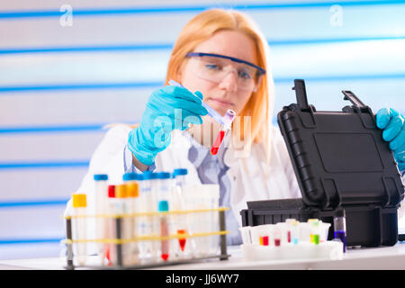 Laboratory assistant in a laboratory with a toxic biological sample in test tube Stock Photo