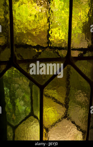 Leadlight windows with hexagonal panes and textured cathedral glass, at Hammond Castle, in Gloucester, Massachusetts. Stock Photo