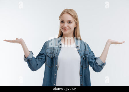 Joyful young woman holding arms bent in elbows Stock Photo