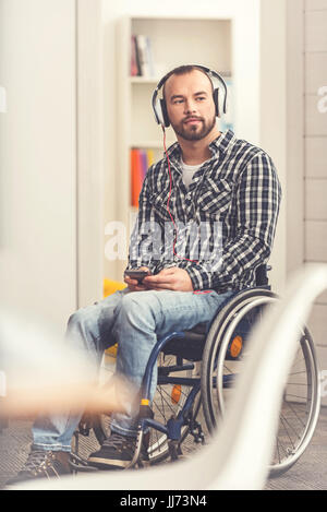 Disabled young man listening to radio Stock Photo