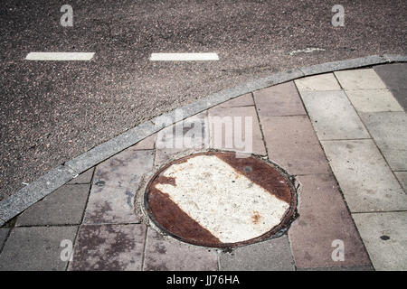 rusty sewer hatch near the road. urban, background. Stock Photo