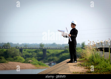 The engineer's eyes were closed, his mind working, his hands on the blueprint. Stock Photo