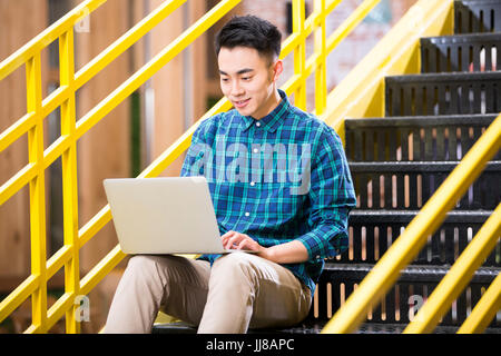 Young man  work on the stairs Stock Photo