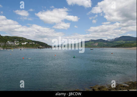 A view of the famous railway bridge over the estuary and harbour at Barmouth in Wales Stock Photo