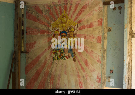 Common Soviet propaganda wall paint in abandoned room in ghost city of Pripyat in Chernobyl Exclusion Zone Stock Photo