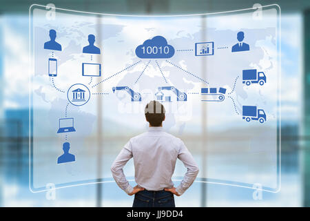 Manager looking at augmented reality (AR) screen showing smart factory or industry 4.0 automated manufacturing connected with internet of things (IOT) Stock Photo