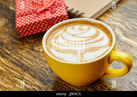 Latte cup on wood. Stock Photo