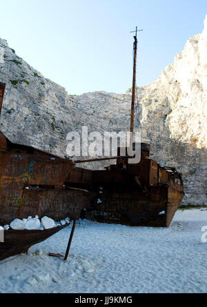 ShipWreck located on white sandy beach and surrounded by white cliffs Stock Photo