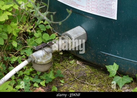 Control on off tap and filter at bottom of domestic bunded oil tank re close up industrial isolation valve heating Stock Photo