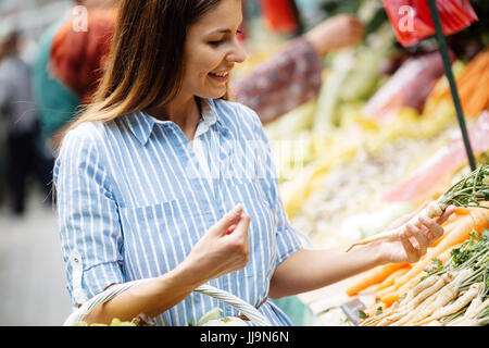 Picture of woman at marketplace buying vegetables Stock Photo